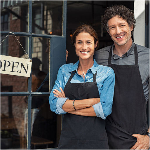 two happy entrepreneurs in front of their store