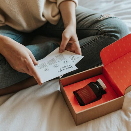 lady opening an ecommerce parcel