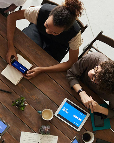 photo of team looking in to their device screen