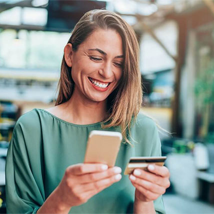 woman paying on phone using card