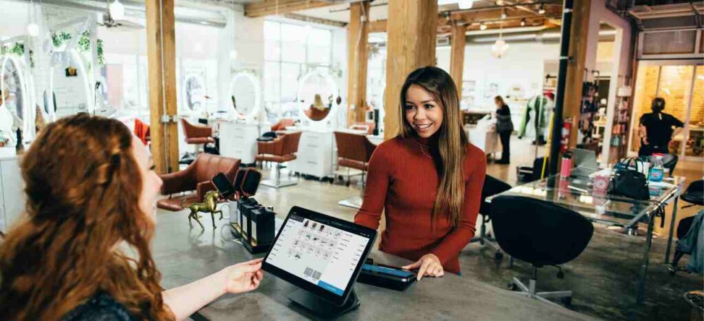 Young woman paying her bill through digital payments