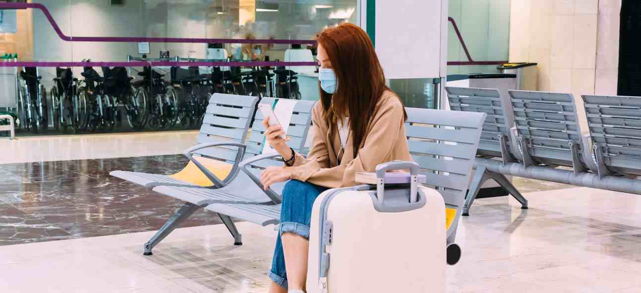 a woman doing online shopping while seated in an airport