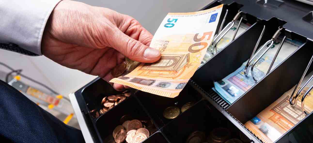 Euro Banknotes And Coins In Cash counter