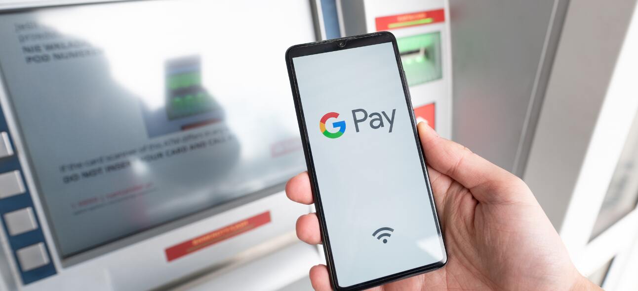 Man Holding Smartphone with Google Pay Logo