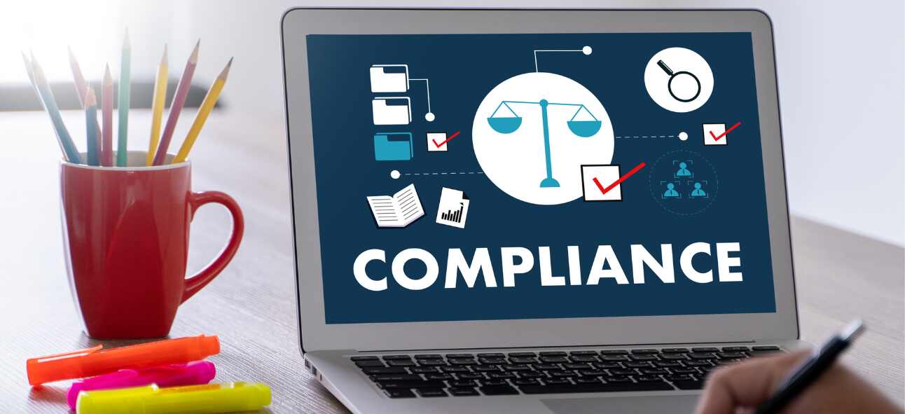 A laptop screen showing compliance