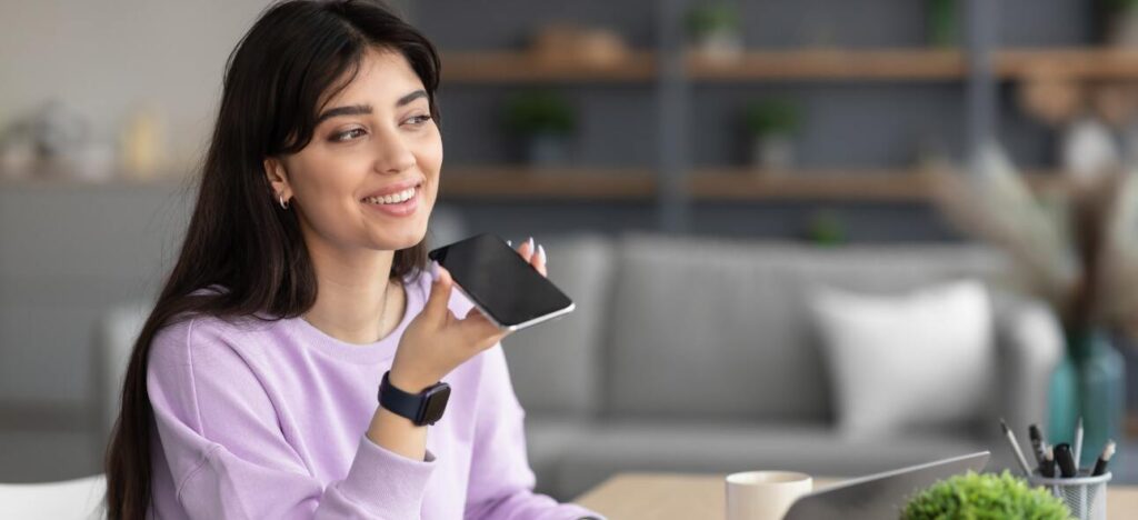 A woman speaking over phone to make voice payment